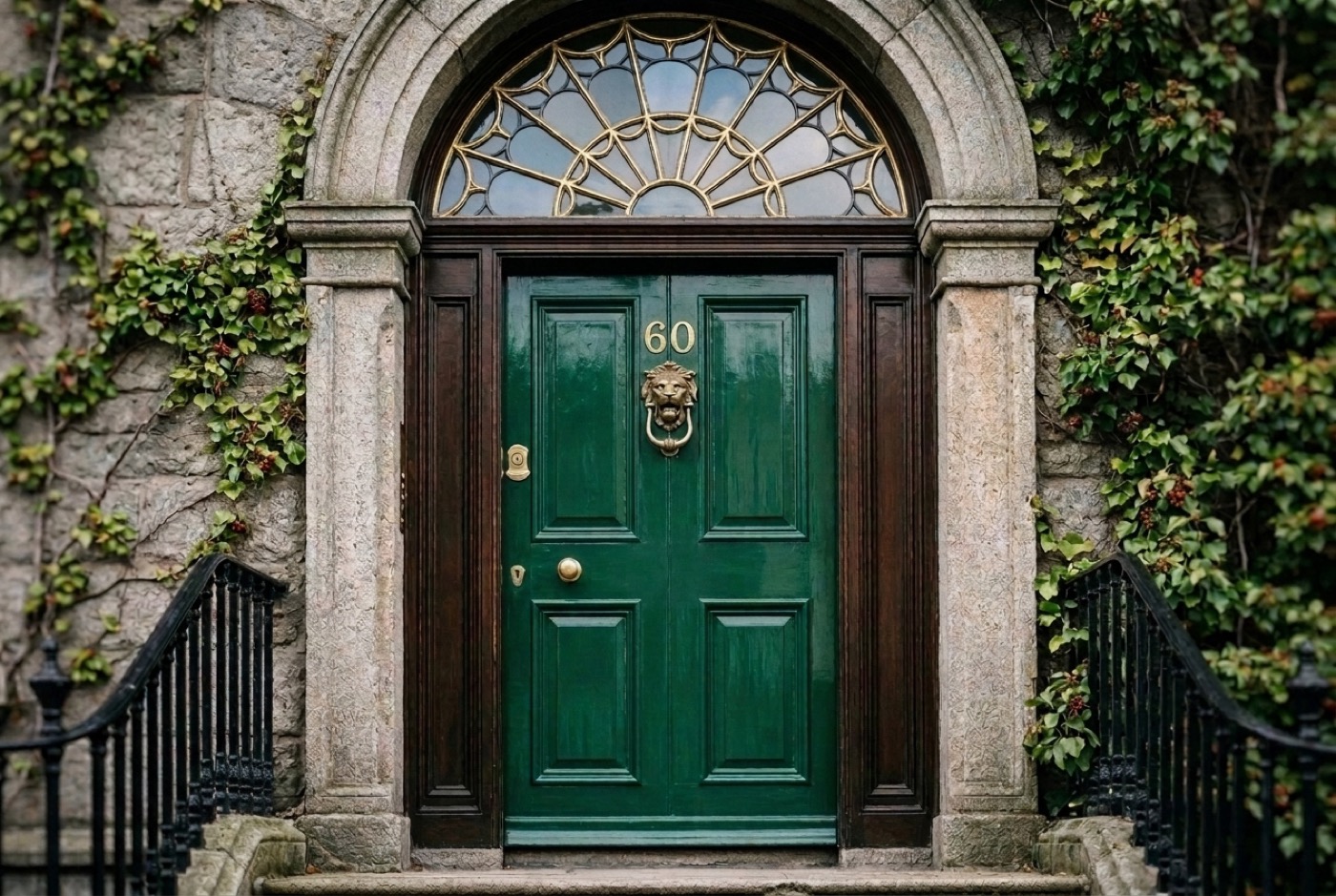 An emerald green Georgian door in Dublin with a gold fanlight above